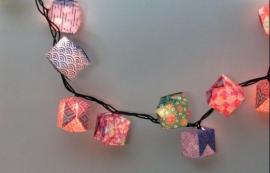 Origami  folded into balloons covering mini lights on a light strand