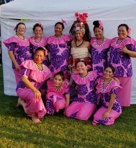 Dance troupe dressed in bright pink and purple