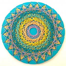 Example of string art project. Circle with string in a rainbow of colors artfully wound around it. 