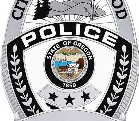 Badge for the City of Sherwood Police Department, featuring the State of Oregon seal, laurel branches, and landscape illustrations.