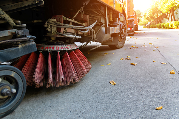 Street sweepers are cleaning city street.