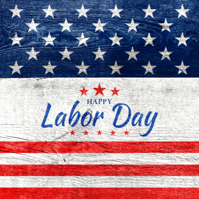 A U.S. flag-themed background with "Happy Labor Day" written in blue letters, red stars above, and red and white stripes below.