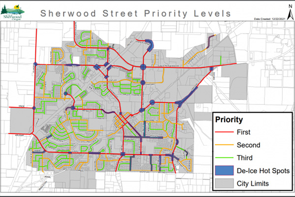 Map of Sherwood showing street priority levels for de-icing: first (red), second (orange), third (green), de-ice hot spots (blue), and city limits outlined in black.