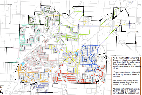 A city map divided into color-coded sections, each representing different areas for street sweeping routes and schedules, with a text box explaining schedule adjustments.