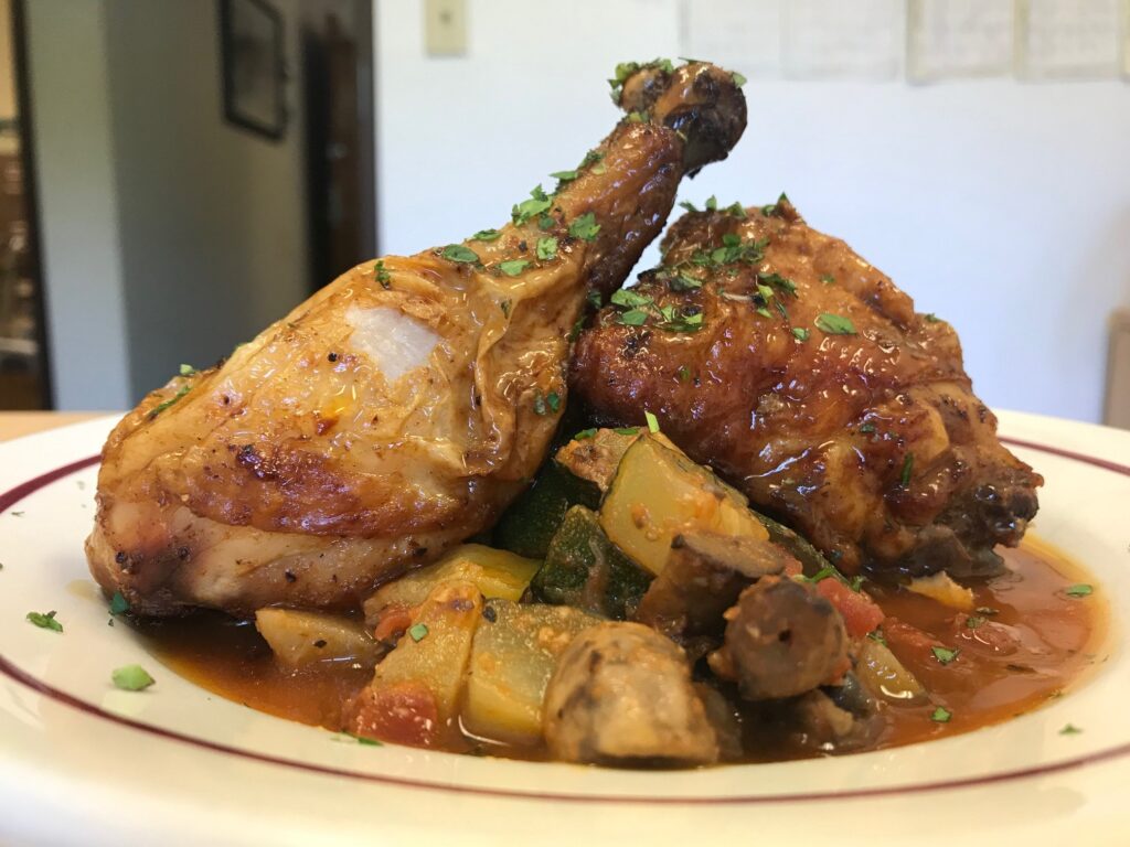 A plate with mashed potatoes and oven-baked chicken.