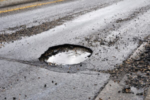 A pot hole filled with water.
