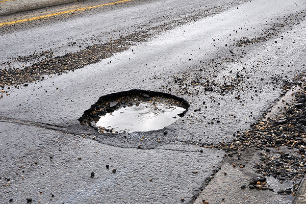 A pot hole filled with water.