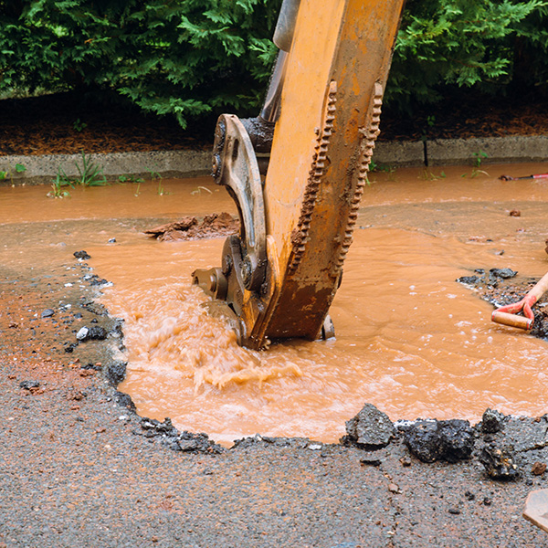A broken water main fills the road with water