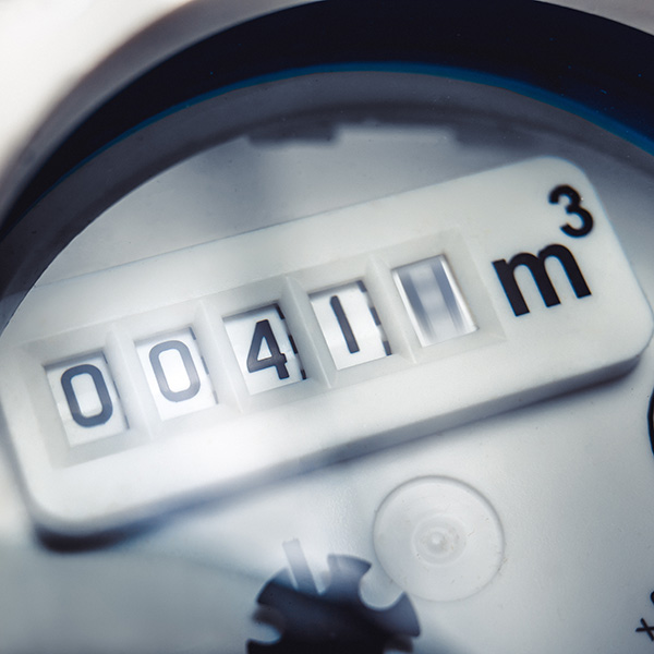 Close up of water meter with rotating digit.