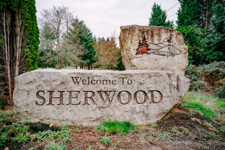 Large stone sign reads 