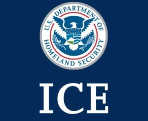 U.S. Department of Homeland Security seal above large white text reading "ICE" on a dark blue background.