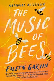 Book cover of "The Music of Bees" by Eileen Garvin, featuring three illustrated bees on an orange and yellow background with white and blue text.
