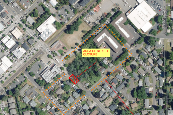 Aerial map showing a highlighted area labeled “Area of Street Closure” at Columbia St and Highland Dr, with dotted orange lines marking the closure boundaries.