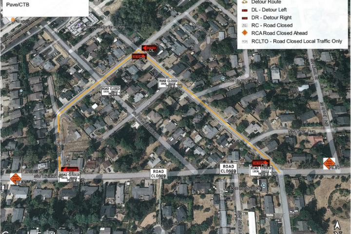 Aerial map of a neighborhood showing a detour route for Washington St, with road closure signs and a legend explaining route symbols.