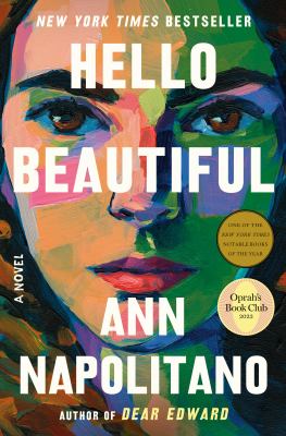 Colorful painted portrait of a woman’s face on the cover of “Hello Beautiful” by Ann Napolitano, featuring award stickers and bold, large text announcing the title and author.